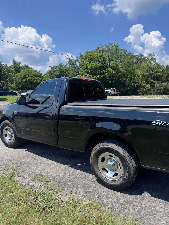 Black Ford F-150 pickup with tinted windows